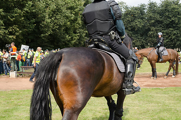 Image showing police horse armed armoured policeman in event 