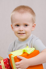 Image showing Year-old boy with a gift looks right