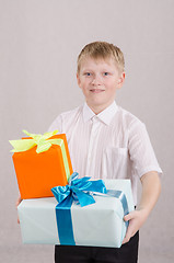 Image showing Portrait of teenage boy with gifts in their hands