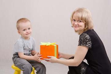 Image showing Mom giving a gift to his son