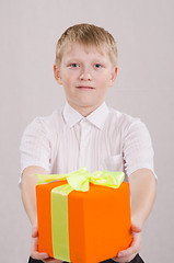 Image showing The boy reluctantly giving a gift