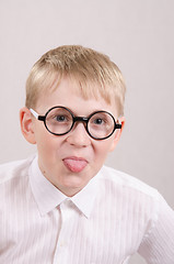 Image showing Teenager in glasses showing tongue