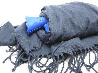 Image showing Blue hot-water bag wrapped in a blue scarf with fringes 