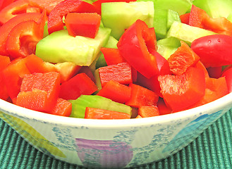 Image showing Slices of cucumber and red pepper in a ceramics bowl