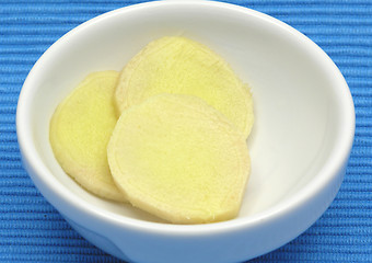 Image showing Ginger in a bowl of chinaware on blue background