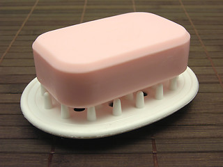 Image showing Pink soap on a soap dish on a brown background