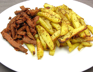 Image showing Soy Geschnetzeltes and french fries on white plate