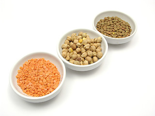 Image showing Three bowls of chinaware with garbanzos lentils and red lentils