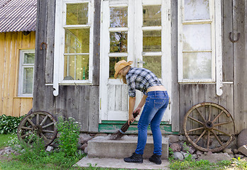 Image showing Worker woman clean sweep stairs with wooden broom 