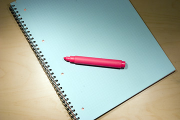 Image showing red marker on blue notepad