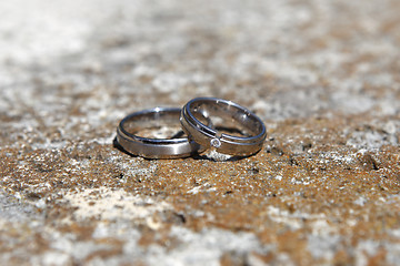 Image showing Wedding rings on a stone wall