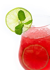 Image showing Glass of red cocktail with lime slices