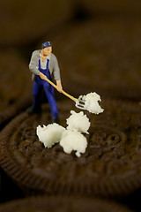 Image showing Plastic People Cleaning Up a Messy Cookie