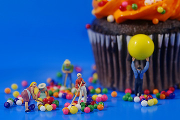 Image showing Plastic People Cleaning Up a Messy Cupcake