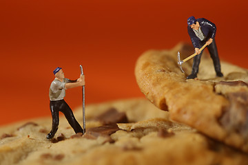 Image showing  Plastic People Working on Chocolate Chip Cookies