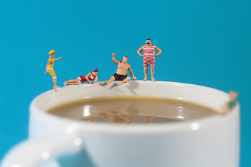 Image showing Plastic People Swimming in Coffee