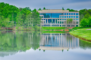 Image showing office building reflecting in lake