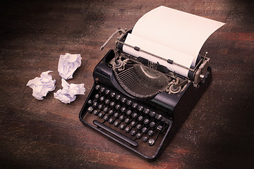 Image showing Vintage typewriter and old books