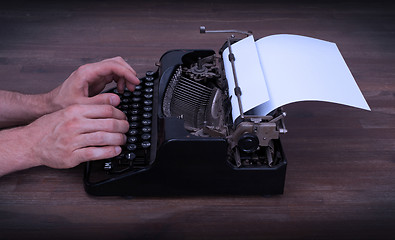 Image showing Writer or reporter behind the typewriter
