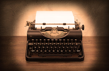 Image showing Vintage typewriter and old books