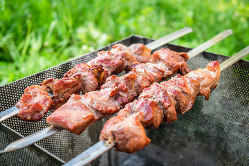 Image showing Hot shish kebab on metal skewers