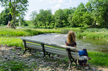 Image showing woman on bench admire fast flow river water stream 