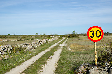 Image showing Speed limit sign at rural tracks in a plain grassland