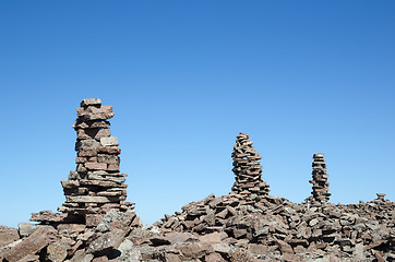 Image showing Group of rock piles at a clear blue sky