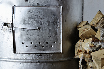 Image showing old stove and birch firewood