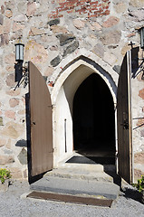 Image showing open doors of medieval stone church
