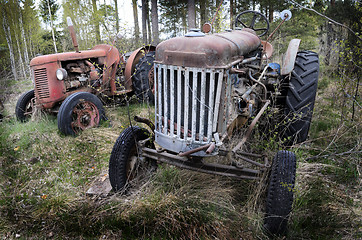 Image showing two old rusty tractor in the forest