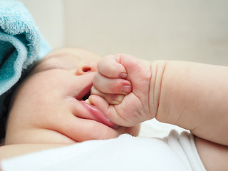 Image showing Baby chewing on hand