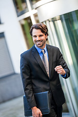 Image showing Motivated businessman punching the air