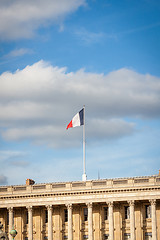 Image showing Flag of France fluttering under a serene blue sky