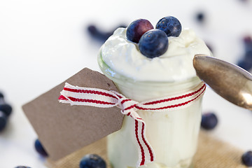 Image showing Jar of clotted cream or yogurt with blueberries