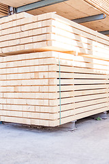 Image showing Wooden panels stored inside a warehouse