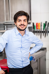 Image showing Friendly attractive man in a commercial kitchen