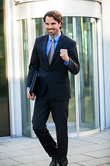 Image showing Motivated businessman punching the air