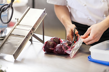 Image showing Chef slicing boiled beetroot