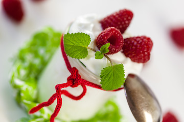 Image showing Raspberries and yoghurt or clotted cream