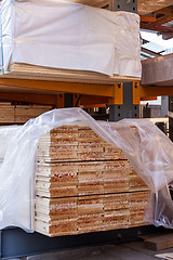 Image showing Wooden panels stored inside a warehouse