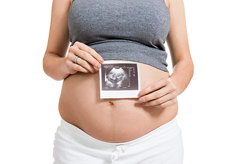 Image showing Pregnant woman displaying a prenatal ultrasound