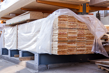 Image showing Wooden panels stored inside a warehouse