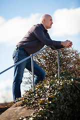 Image showing Thoughtful man sitting on a flight of steps