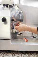 Image showing Commercial cook or chef slicing cold meat