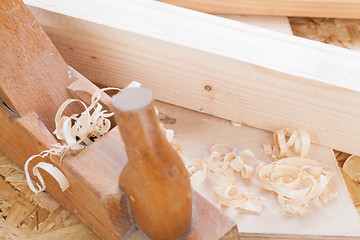 Image showing Handheld wood plane with wood shavings