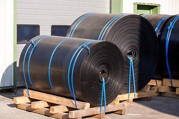 Image showing Rolls of black industrial plastic