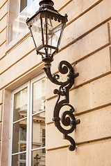 Image showing Old wrought iron lamp on a building exterior