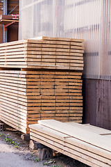 Image showing Wooden panels stored inside a warehouse