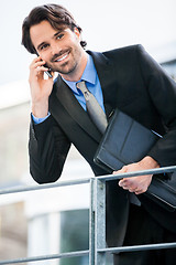 Image showing Businessman listening to a call on his mobile